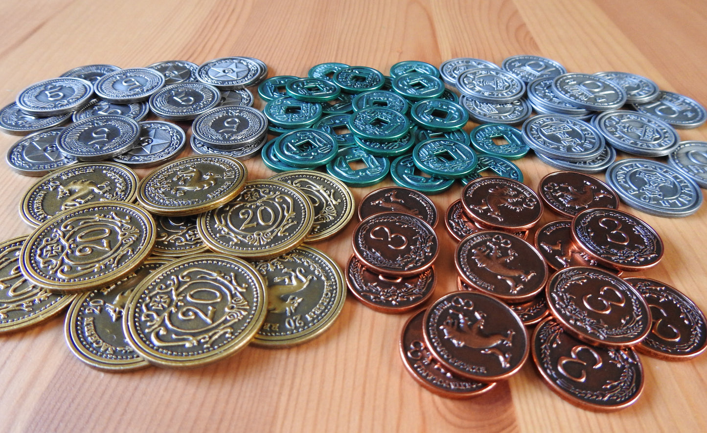 View of the 80 metal coins for the Scythe base game that are included in this accessory.
