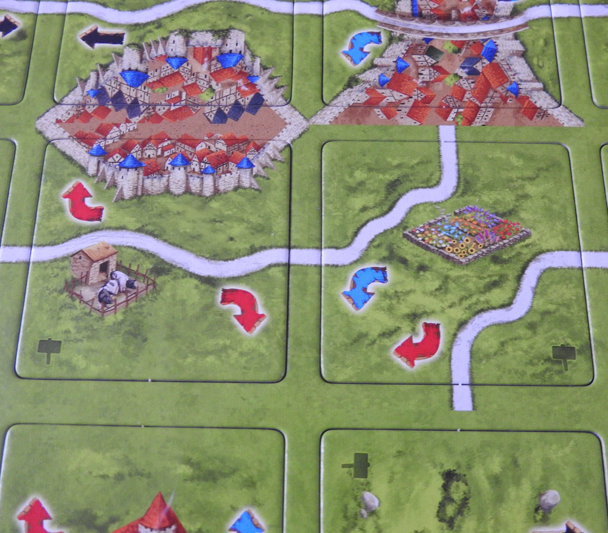 Closer view of two of the included tiles, with arrows pointing in different directions.