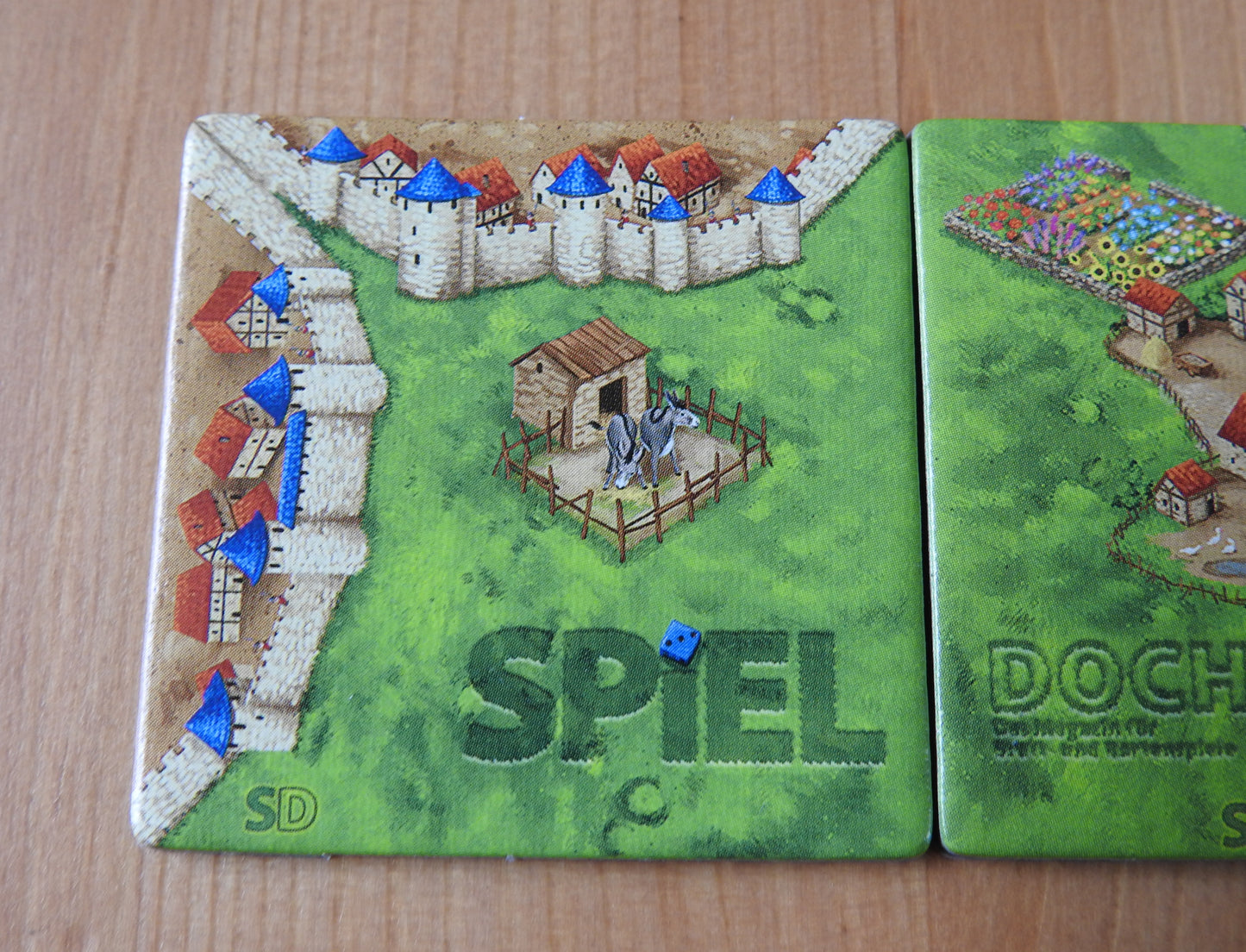 A closer view of the 'Spiel' tile featuring a donkey's stable as part of this mini expansion for Carcassonne.