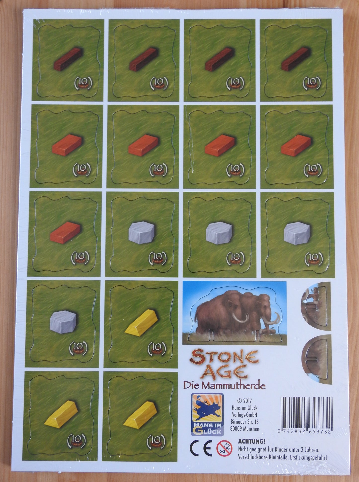 Top view of the 16 tiles and mammoth pieces included with this Stone Age - Mammoth Herd mini expansion.