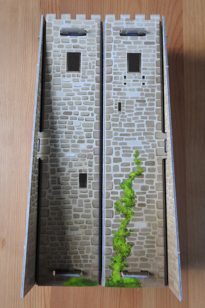 View of the back of the Tile Tower accessory for Carcassonne, showing the lovely brickwork and plants on the outside wall.