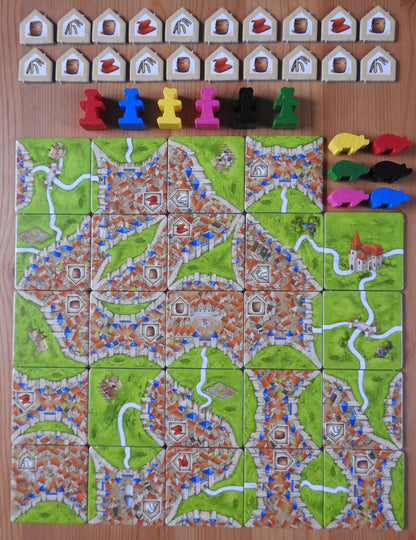 View of all the tiles and pieces included in this Carcassonne Traders & Builders Unboxed expansion.