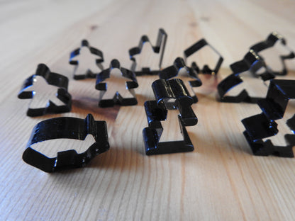 Close-up view of some of the meeple tokens included, such as the pig and abbot.