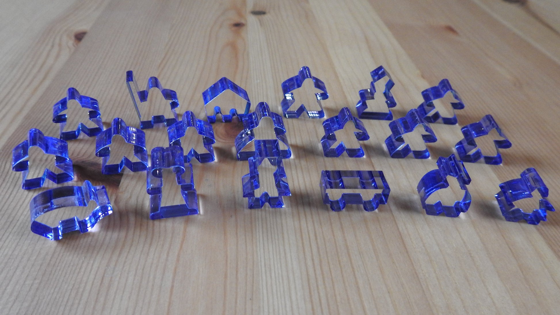 Close-up view of the blue transparent meeple set.