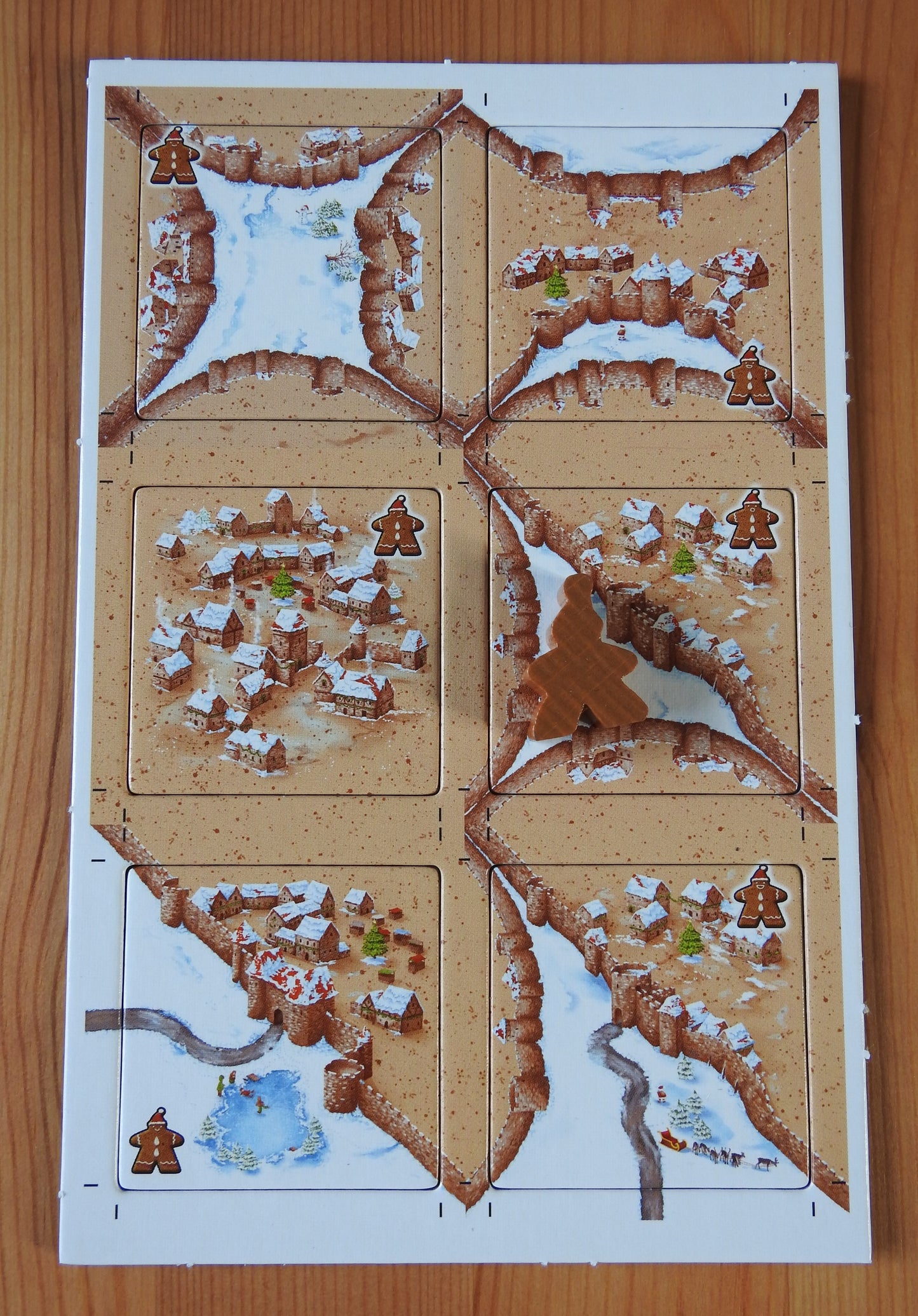 Top view of the Carcassonne Winter Gingerbread Mini Expansion, showing all six tiles and the gingerbread man meeple.