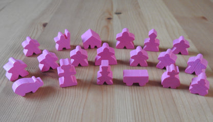 Close-up view of the pink wooden meeple set.
