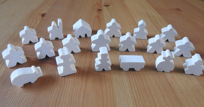 Close-up view of the white wooden meeple set.
