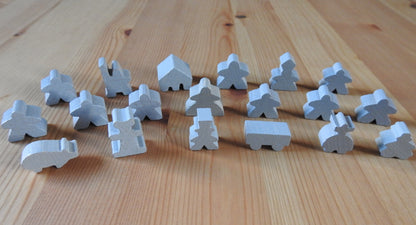 Close-up view of the grey wooden meeple set.