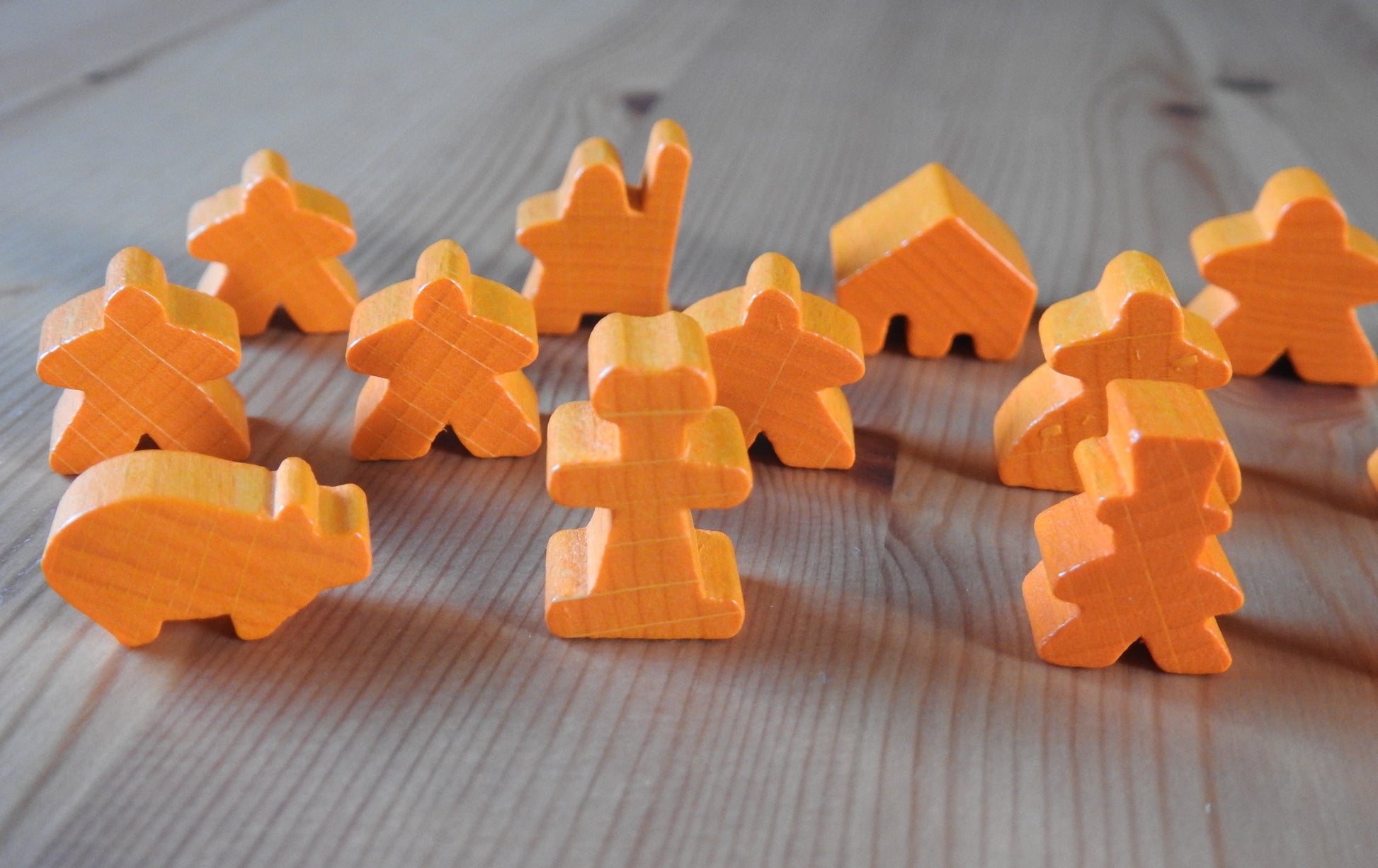 Close-up view of the orange pig, abbot and other meeple figures included.